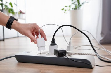 Elektrik prizini takan adam. Evdeki prizin prizine elektrik prizi takın.