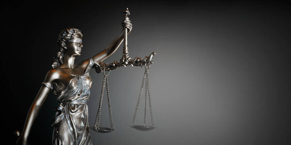 The Statue of Justice symbol on dark background