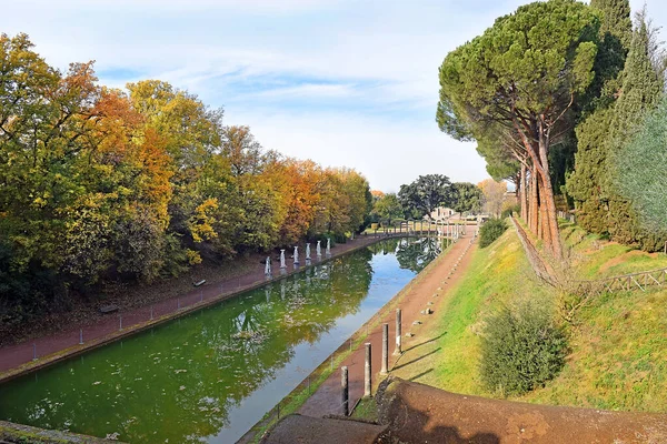 阿德里安别墅 Villa Adriano 的古希腊雕塑环绕的称为 Canopus 的古老游泳池 以及意大利蒂沃利的水中倒影 — 图库照片
