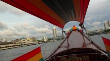 Riding a motor boat tour on Chao Phraya river in Bangkok, Thailand. 