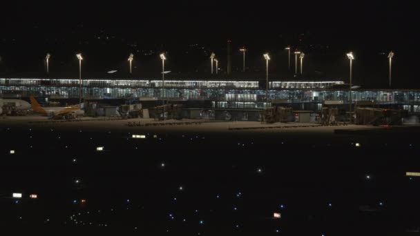 Samolot Zbliża Się Startu Nocy Tle Terminalu Lotniska Oświetlonymi Szybami — Wideo stockowe