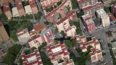 İniş yapan bir uçağın gölgesi binalara ve şehir yollarına düşüyor.