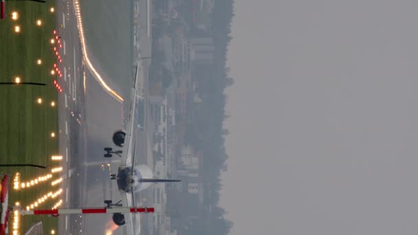 Vertikal Video Ett Passagerarflygplan Som Landar Starkt Upplyst Bana — Stockvideo