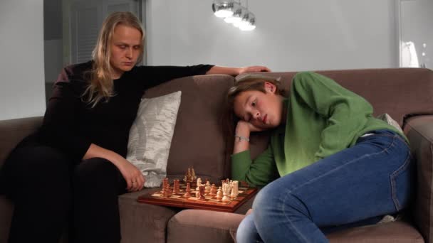 Boy Plays Chess His Mother Home Sitting Sofa — Αρχείο Βίντεο
