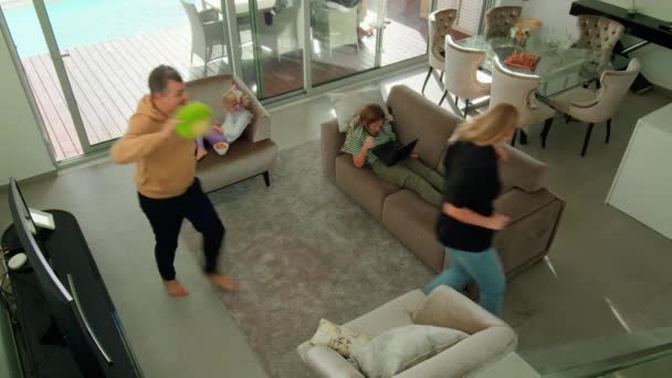 Top Perspective Parents Playfully Chase Each Other Toss Soft Toy — Stock Video
