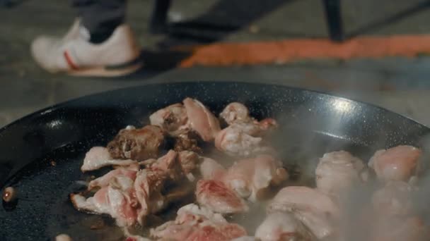 Kock Tillsätter Salt Till Stekande Kyckling Paella Pan Över Öppen — Stockvideo