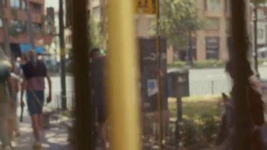 Trafiğin yansıması ve İspanya 'da cadde boyunca yürüyen insanlar Valencia girişteki cam kapıdan görülebiliyor.