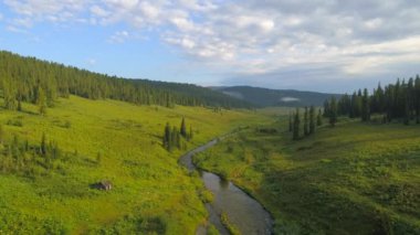 İdyllic Sibirya yaz sahnesi nehri, mavi gökyüzü, bulutlar, dağlar, sabah sisi, küçük orman evi..
