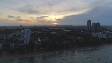 Jomtien Sahili 'nde gün doğumu, Pattaya, Tayland. Altın saat şehri ve denizi aydınlatıyor, çarpıcı bir manzara yaratıyor..