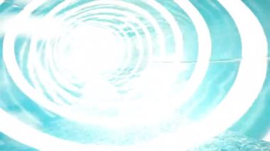 Suyun FPV perspektifi parlak güneş ışığıyla aydınlatılan mavi bir su kaydırağından hızla akıyor.