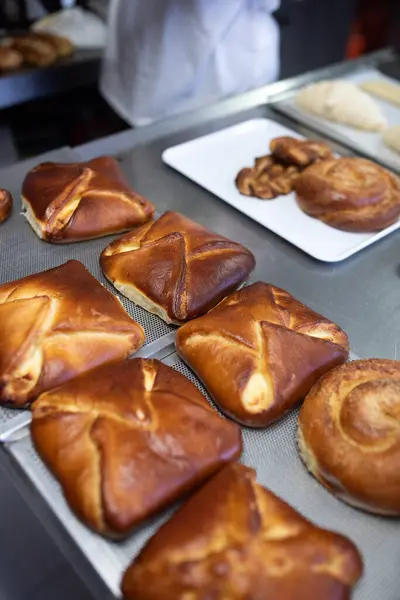 Chef baker makes squirrels in a pastry shop
