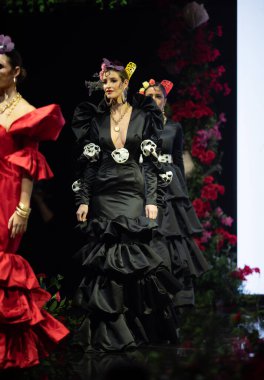 JEREZ, SPAIN - 2 Şubat 2024: Pasarela Flamenco festivalinde kadın giyim şovu. Flamenko elbise gösterisi.
