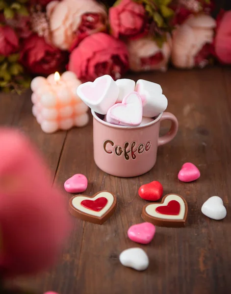souffle cake in the form of heart with cup of coffee on a wooden table
