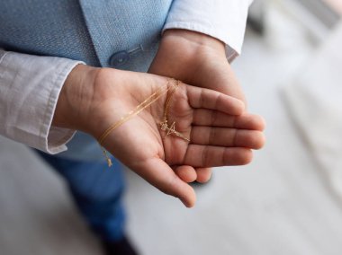 A Catholic cross is in children's hands clipart