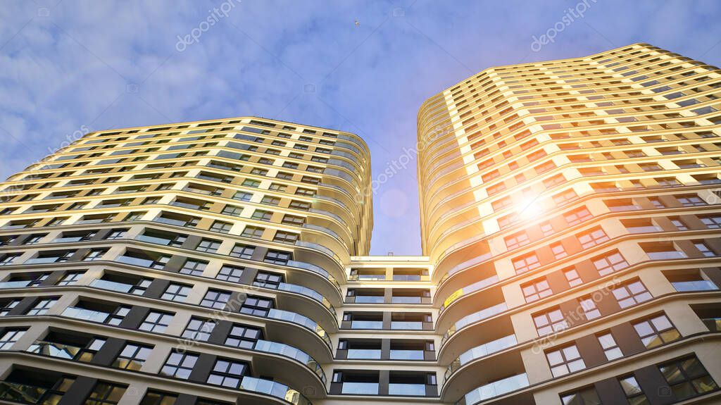 The narrow passage between modern residential buildings. Walls of high