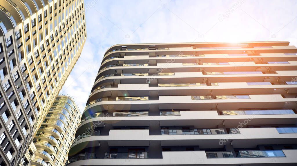 The narrow passage between modern residential buildings. Walls of high