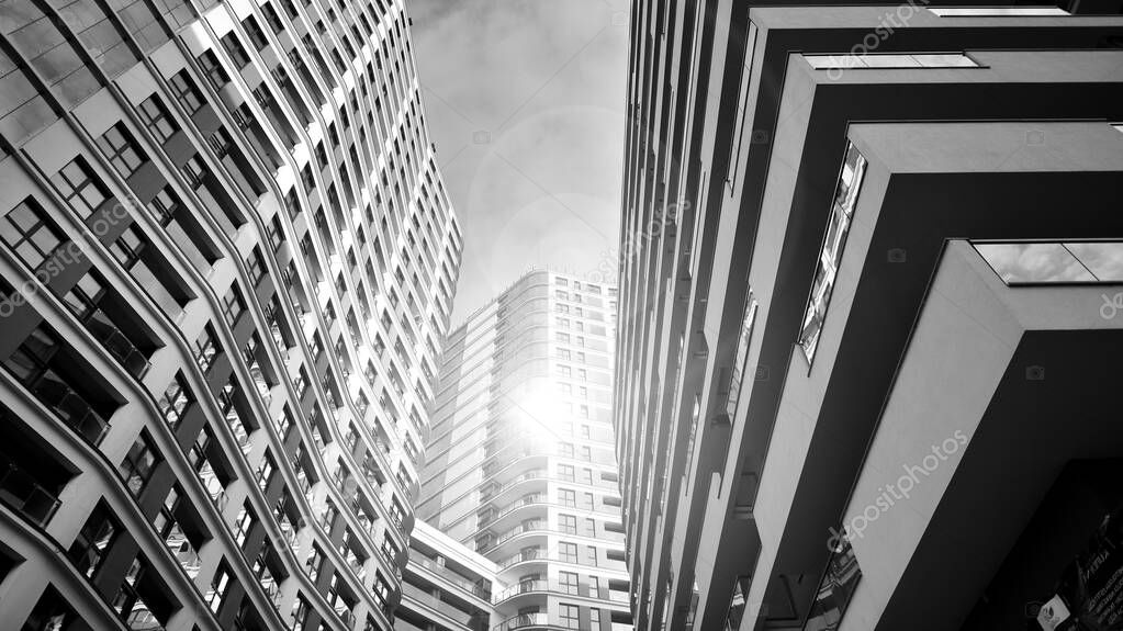 The narrow passage between modern residential buildings. Walls of high