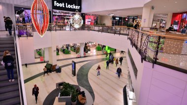 Warsaw, Poland. 19 January 2023. People in the mall on shopping. The idea of consumerism. Shoppers passing by in the Westfield Arkadia shopping mall.