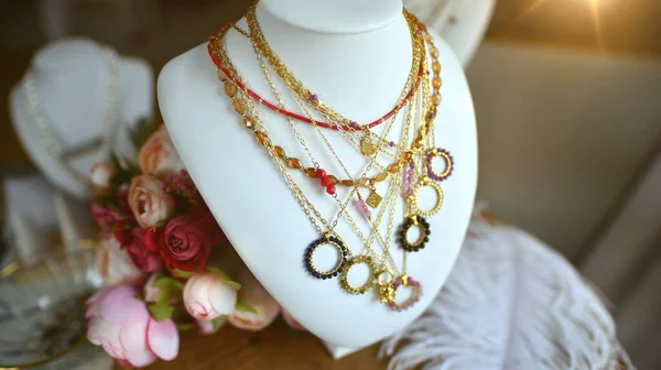 Stylish necklace, fashionable accessorize details. Stylish necklace with gemstones on jewelry bust.
