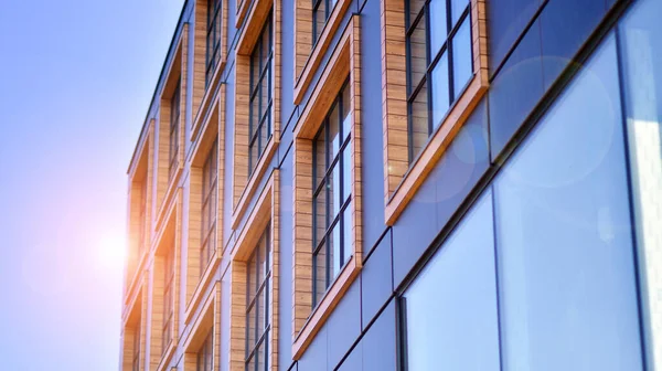 stock image A modern corporate building in the city.  The blue sky is reflected in the buildings large glass windows. Glass facade.