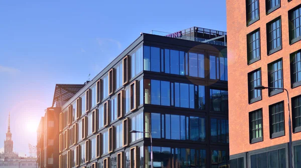 stock image A modern corporate building in the city.  The blue sky is reflected in the buildings large glass windows. Glass facade.