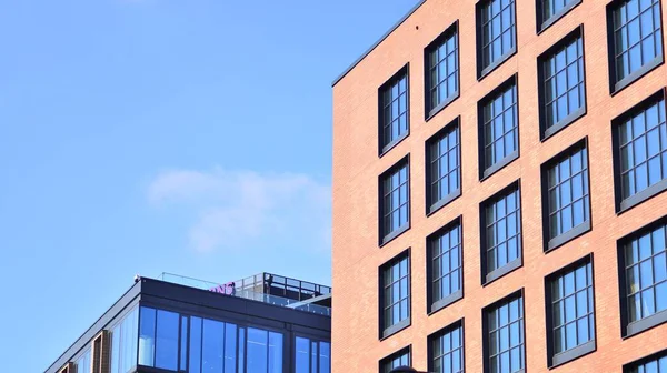 stock image A modern corporate building in the city.  The blue sky is reflected in the buildings large glass windows. Glass facade.