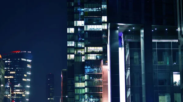 stock image Pattern of office buildings windows illuminated at night. Glass architecture ,corporate building at night - business concept. Blue graphic filter.