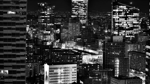 Warsaw, Poland. 14 March 2023. Beautiful architecture of Warsaw city center with modern skyscrapers at night. Black and white.