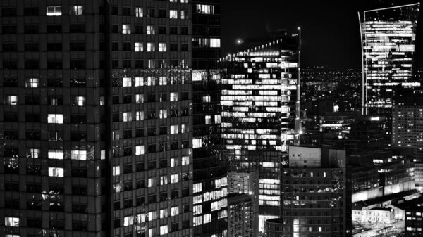 View of at night glass buildings and modern business skyscrapers,. View of modern skyscrapers and business buildings in downtown. Big city at night. Black and white.