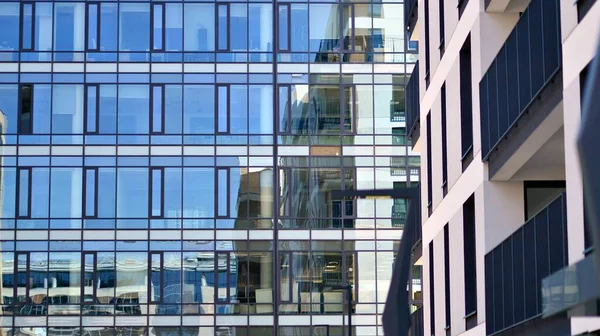 ガラスとコンクリートで作られた現代建築 壁の抽象的な断片 反射板ガラスで覆われたモダンな建物のガラス張りのファサードの抽象的な閉鎖 — ストック写真