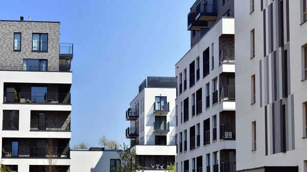 stock image Modern apartment buildings on a sunny day with a blue sky. Facade of a modern apartment building. Contemporary residential building exterior in the daylight. 