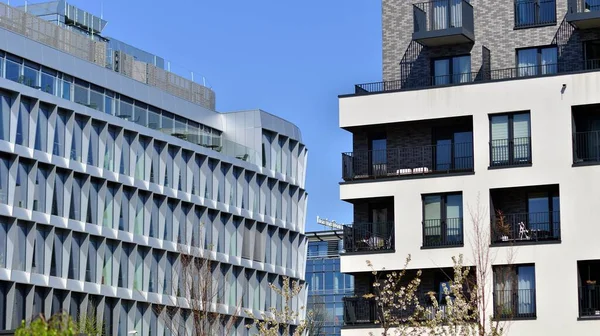 Stock image Modern apartment buildings on a sunny day with a blue sky. Facade of a modern apartment building. Contemporary residential building exterior in the daylight. 