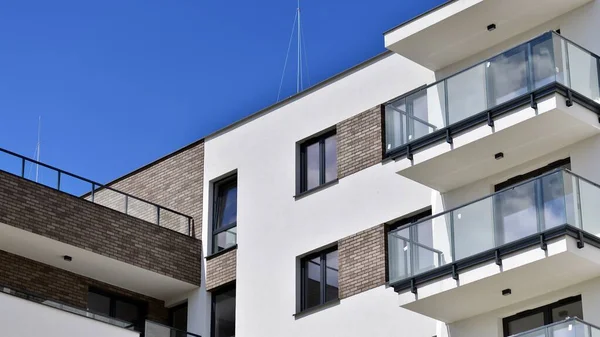 Stock image  Modern apartment buildings on a sunny day with a blue sky. Facade of a modern apartment building. Contemporary residential building exterior in the daylight. 