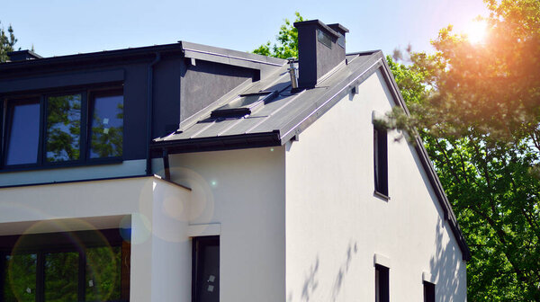 Terraced family homes in newly developed housing estate. The real estate market in the suburbs. New single family houses in a new development area. Residential homes with modern facade. 