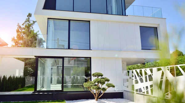 Elegant white house with open concept. Modern luxury villa exterior. A modern house with large windows and glazing.