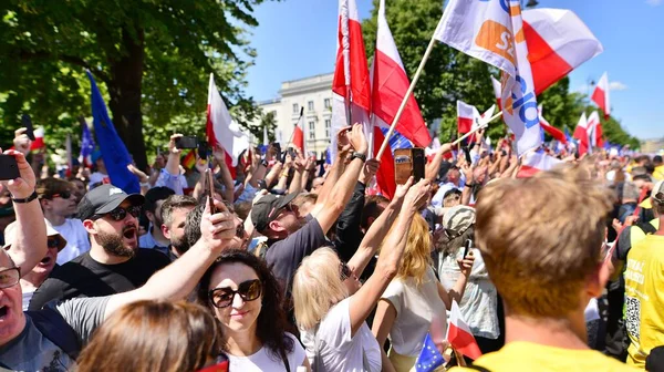 Stock image Warsaw, Poland. 4 June 2023. Hundreds of thousands march in  anti-government protest to show support for democracy. The spontaneous reaction of people during the great March of the opposition.