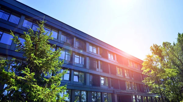 stock image Sustainable glass office building with trees for reducing carbon dioxide. Eco-friendly building in modern city. Office with green environment. Corporate building reduce CO2.