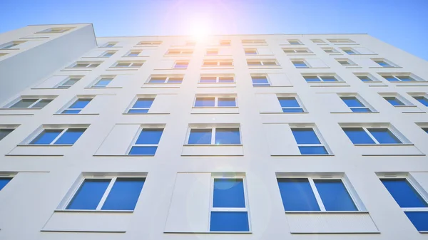 Stock image Contemporary residential building exterior in the daylight. Modern apartment buildings on a sunny day with a blue sky. Facade of a modern apartment building. 