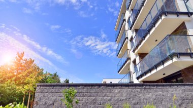 Eco city with modern exterior design of apartment building and landscaping. Garden yard by residential buildings.. Contemporary eco friendly residential architecture. Eco-friendly living in a city.