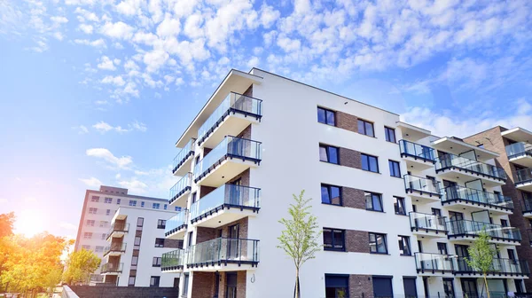 Eco city with modern exterior design of apartment building and landscaping. Garden yard by residential buildings.. Contemporary eco friendly residential architecture. Eco-friendly living in a city.