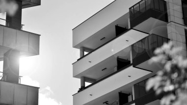 Güneşli bir günde modern apartman binası. Dış görünüş, ev cephesi. Siyah ve beyaz.
