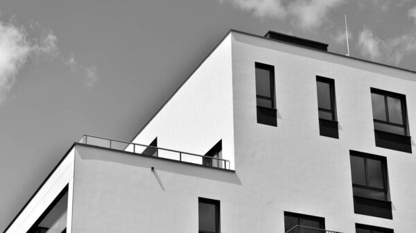 Modern apartment building in sunny day. Exterior, residential house facade. Black and white.