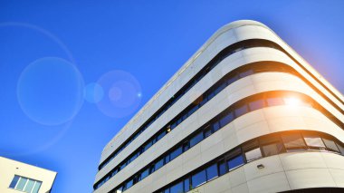 Beyaz metalik ön cepheli ve pencereli modern ofis binası. Modern mimari ayrıntılar.