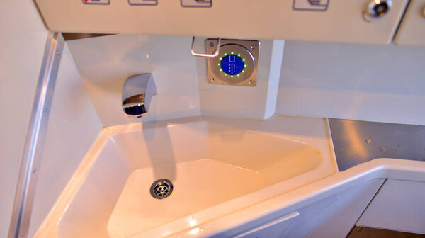 Pedestrian and bicycle traffic light with bicycle icon and active green resolving light on the background of summer city