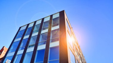 Architecture details. Modern glass building facade in sunny day. Business background.