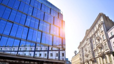 Architecture details. Modern glass building facade in sunny day. Business background.