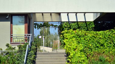 Ağaçların çevresindeki modern bir yerleşim yeri. Ekoloji ve yeşil yaşam şehirde, kentsel çevre kavramı. Modern apartman ve yeşil ağaçlar. Ekolojik konut mimarisi. 