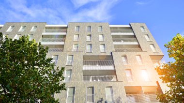 Modern yerleşim alanı. Yeni apartmanın yakınındaki ağaçlar. Doğa dostu lüks gayrimenkul.