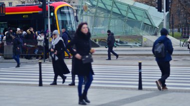 Varşova, Polonya. 29 Aralık 2023. Kalabalık kalabalık trafiğin en yoğun olduğu saatte trafik ışığı zebrasıyla karşıdan karşıya geçiyor. Europa 'da büyük bir şehirde yaşam tarzı.