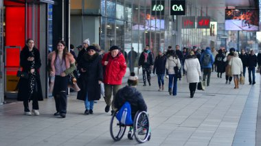 Varşova, Polonya. 29 Aralık 2023. Farklı yaş ve milletten insanlar kış zamanı şehir merkezinde yürür. Sokaktaki insanlar.
